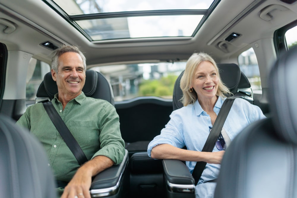 Couple enjoying private ride in luxury car – Hughes premium chauffeur service